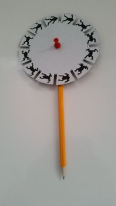 a pencil is sticking out of a paper clock