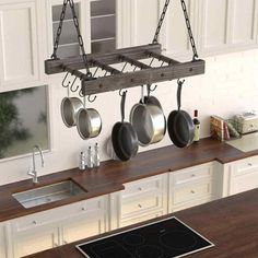 an island with pots and pans hanging from it