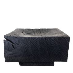 an upholstered black leather ottoman or footstool with wood grain patterning