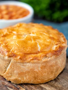 a baked pot pie sitting on top of a wooden cutting board