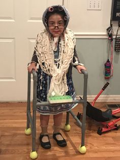 an old woman sitting in a chair with a green cake on it's lap