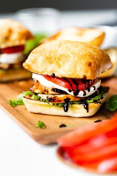 there are two sandwiches on the cutting board