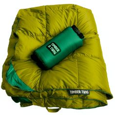 the sleeping bag is green and has a water bottle on it