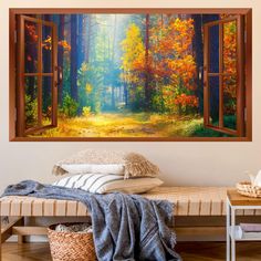 an open window showing a forest scene with trees and leaves in the fall colors, on a wall above a bed