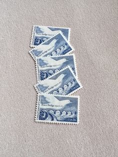 five postage stamps are laying on the ground