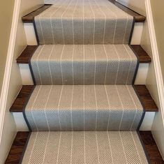 a carpeted staircase leading up to the second floor