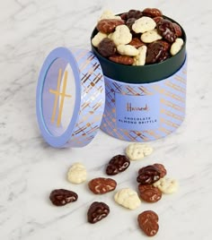 a blue tin filled with nuts and raisins on top of a marble counter