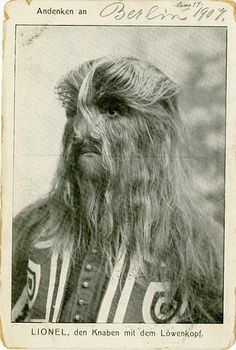 an old black and white photo of a man with long hair