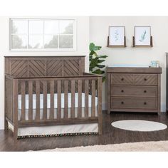 a baby crib and dresser in a room