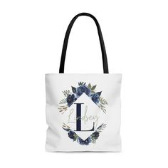 Our Personalized Blue Floral Initial Name Tote Bag makes a great gift for a friend, family member, coworker, bridesmaid or even a gift to yourself. This practical, high-quality Tote Bag is available in three sizes. All over print provides comfort with style at the beach or out in town. Made from reliable materials, lasting for seasons. Features: - 100% Polyester - Boxed corners - Black cotton handles - Black lining Care Instructions: Before cleaning the bag, remove all the items from bag. Sugges Personalized Blue Bags For Daily Use, Blue Shoulder Bag For Gift, Personalized Blue Rectangular Bag, Blue Rectangular Bags For Gifts, Elegant Personalized Bags For Gifts, Elegant Personalized Bags As Gifts, Blue Monogram Bags For Everyday Use, Blue Monogram Bag For Everyday Use, Personalized Rectangular Bag With Custom Name