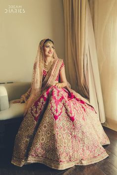 a woman in a wedding dress sitting on a couch