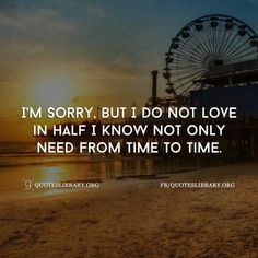 a ferris wheel sitting on top of a beach next to the ocean with a sunset in the background