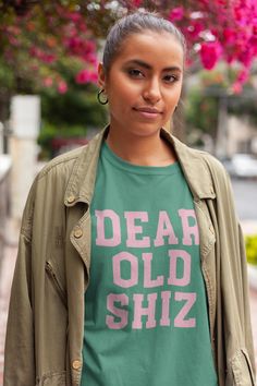 a woman wearing a t - shirt with the words dear old shiz on it