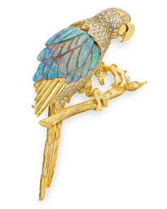 This inventive brooch by famed goldsmith and designer Henry Dunay takes the unique shape of a tropical Macaw bird. The playful design features a rare fossilized opal that totals an impressive 21.69 carats. Carved to appear like the bird's feathers, the bird's body is forged in 18K yellow gold and encrusted in sparkling white diamonds totaling 2.01 carats. Whimsical yet refined, this brooch showcases the creative aesthetic of Henry Dunay jewels. 2 3/4" length Macaw Bird, Jean Schlumberger, Brooch Design, Charleston Art, Animal Themed Jewelry, Creative Aesthetic, Peruvian Blue Opal, Fancy Jewelry Necklace, Yellow Opal