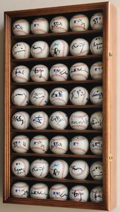 a wooden case holds baseballs with autographed players on them and signed numbers