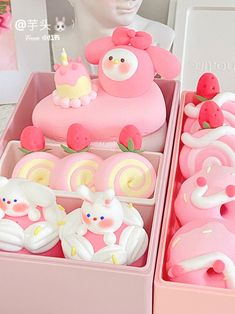 two trays filled with different types of cakes and candies on display in front of a mannequin's head