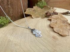 Silver Oak Leaf Necklace This delicate woodland necklace is handcrafted from sterling silver and features the actual impression of a leaf. This beautiful leaf necklace is crafted in our UK studio and can be made with a 16inch or 18inch chain. Pictured is a 16inch chain. Your necklace will be handmade to order and arrive packaged in a Curious Magpie gift box. Materials: Oak Leaf: 925 Sterling Silver Chain: 925 Sterling Silver Size: approx. 20mm length x 10mm width Delivery: Your necklace will be crafted and dispatched within 3-7 business days. Check out our shop for our full range: www.etsy.com/uk/shop/CuriousMagpieDesigns Leaf Necklace Silver, Oak Leaf Necklace, Silver Oak, Oak Leaf, Leaf Charms, 925 Sterling Silver Chain, Leaf Necklace, Leaf Pendant, Silver Leaf