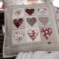 a decorative pillow with hearts on it