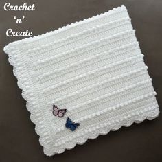 a crocheted dishcloth with two butterflies on it and the words crochet n'create