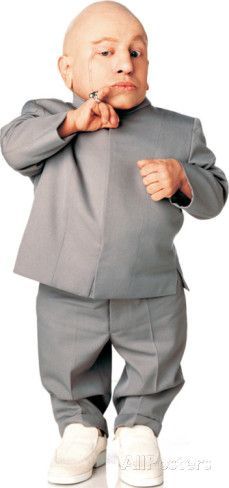 a bald man in a suit is standing with his hands on his chin and looking at the camera