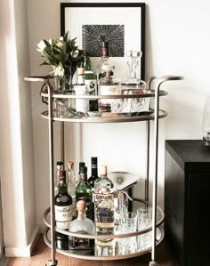 a bar cart filled with liquor bottles and glasses