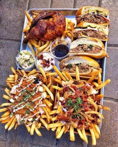 a tray filled with lots of different types of food on top of a brick floor