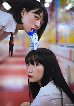 two young women are looking at each other