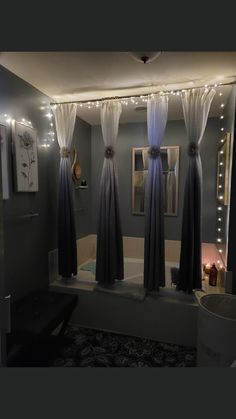 the bathroom is decorated with lights and curtains