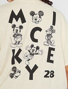 a man wearing a mickey mouse t - shirt with the word mickey on it in black and white