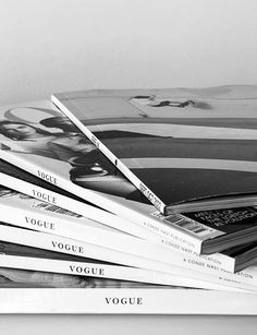 black and white photograph of magazines stacked on top of each other