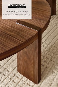 a close up of a wooden table on a carpeted floor with white rugs