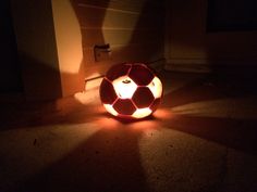 a light up soccer ball sitting on the ground