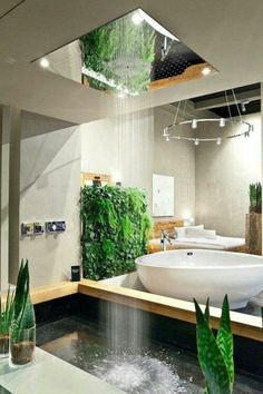 a bathroom with plants growing on the wall and in the bathtub, along with a large mirror