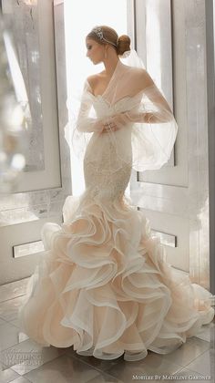 a woman in a wedding dress is posing for the camera