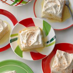 four plates with desserts on them and one has white frosting in the middle