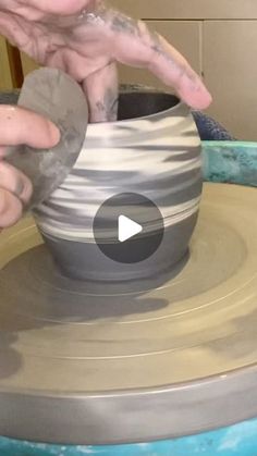 a person making a vase out of clay on top of a pottery wheel with their hands