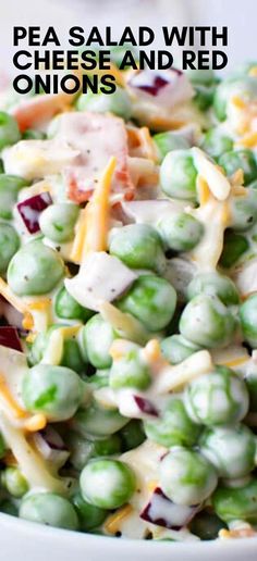 pea salad with cheese and red onions in a white bowl on top of a table