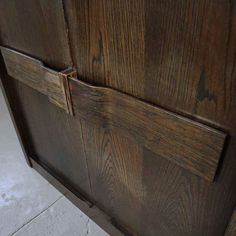 an old wooden cabinet with two handles on it