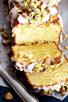 a cake with white frosting and pistachio toppings