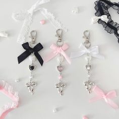 four different types of keychains with bows and hearts on them, all tied together