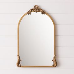 an ornate gold mirror hanging on the wall