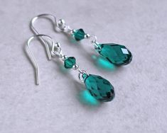 "Emerald green crystal teardrop earrings are made with emerald crystal teardrops accented with silver or gold beads.  They dangle 1\"  from sterling silver or gold fill ear wires. Emerald is the birth crystal color for May.  ❖  Crystal Passions crystals ❖  silver or gold fill beads ❖  .925 sterling silver or 14k gold fill ear wires Earrings shown are on french hook ear wires.  All earring types are sterling silver or gold fill with the exception of clip-ons, which are silver or gold plated. Hypoallergenic french hooks are stainless steel." Green Sterling Silver Teardrop Earrings Hypoallergenic, May Birthstone Teardrop Earrings, Teardrop Green Crystal Earrings, Green Teardrop Birthstone Earrings, Briolette Jewelry, Craft Earrings, Briolette Earrings, Emerald Green Crystal, Wire Jewelry Rings