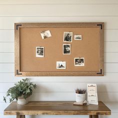 a cork board with pictures on it and a potted plant sitting next to it