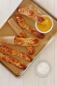 bread sticks and dipping sauce on a tray