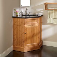 a bathroom with a sink, mirror and towel rack on the wall next to it