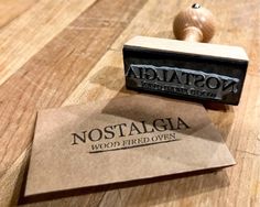 a rubber stamp that says nostalgica wood fired oven on top of a wooden table