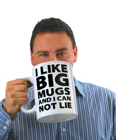 a man holding a coffee mug with the words i like big mugs and i can not lie