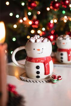 two snowman mugs with marshmallows in them