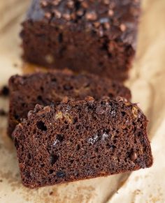 chocolate banana bread is cut in half and stacked on top of each other with the words rich, moist & healthy double chocolate banana bread