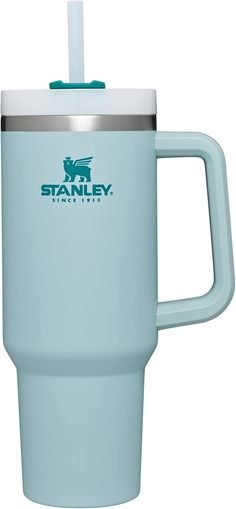 the stanley travel mug is light blue and has a straw in it